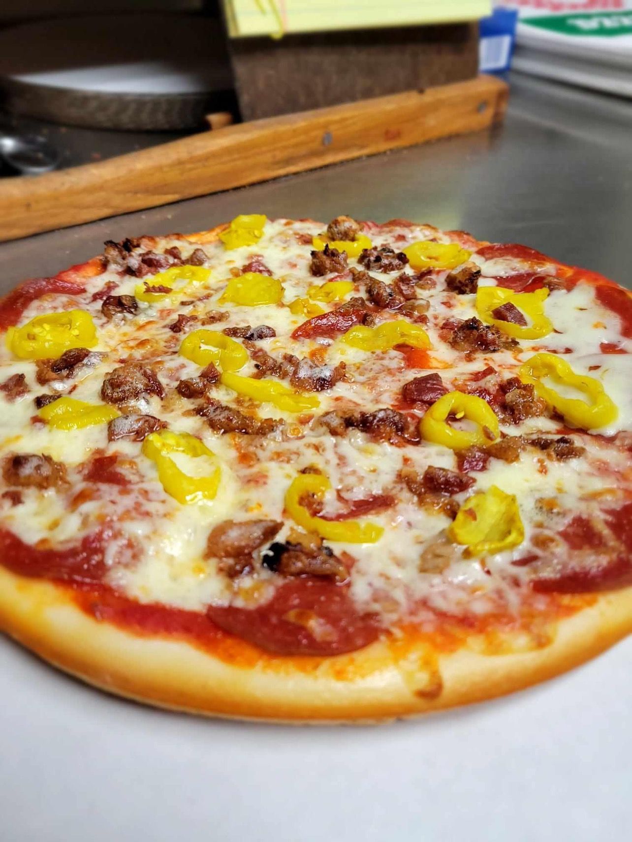 A close up of a cheese stick pizza on a plate.