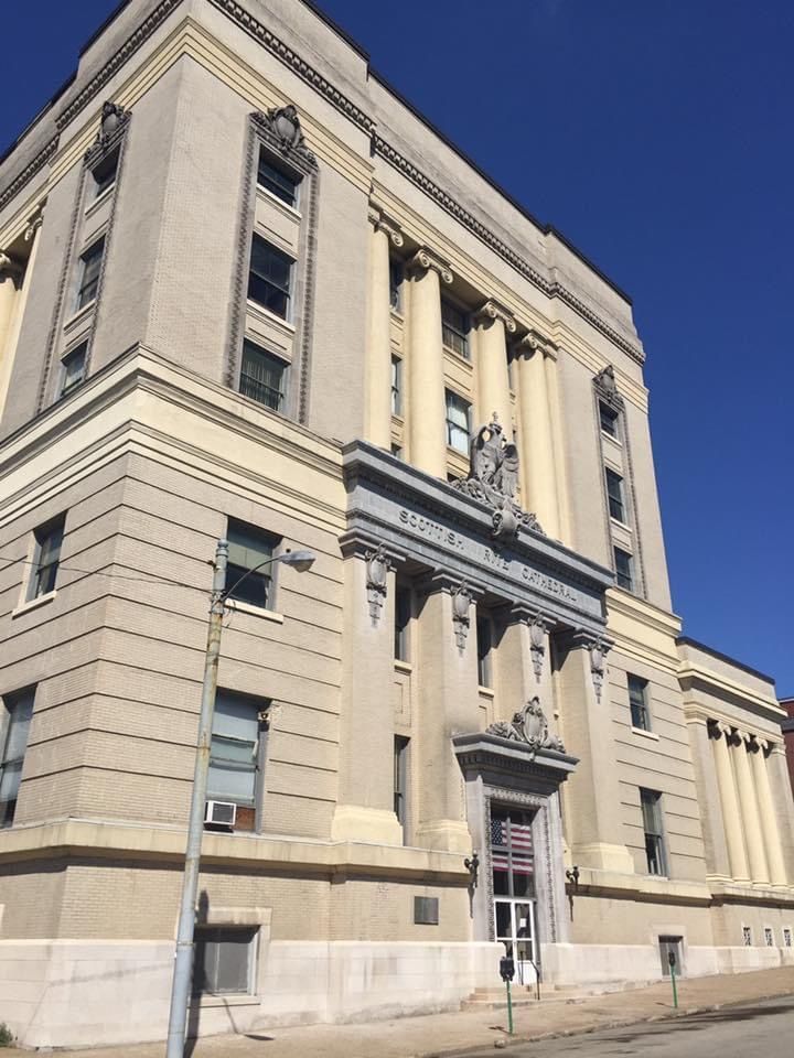A large historic building with a blue sky in the background