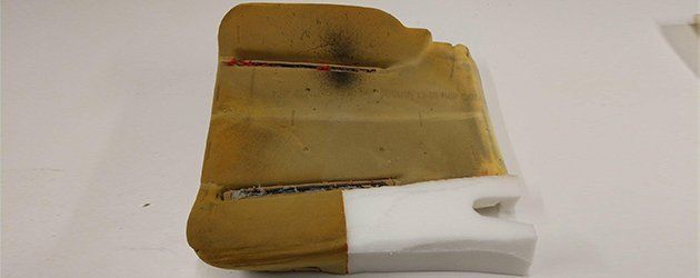 A piece of foam is sitting on top of a white surface