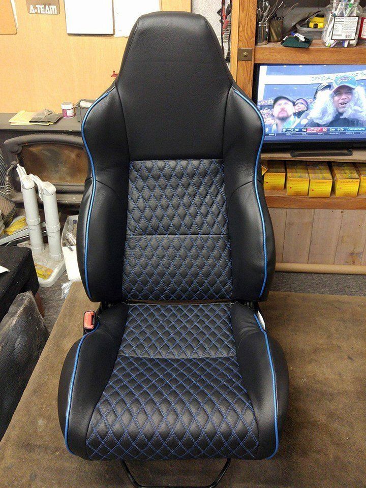 A black and blue car seat is sitting on a table