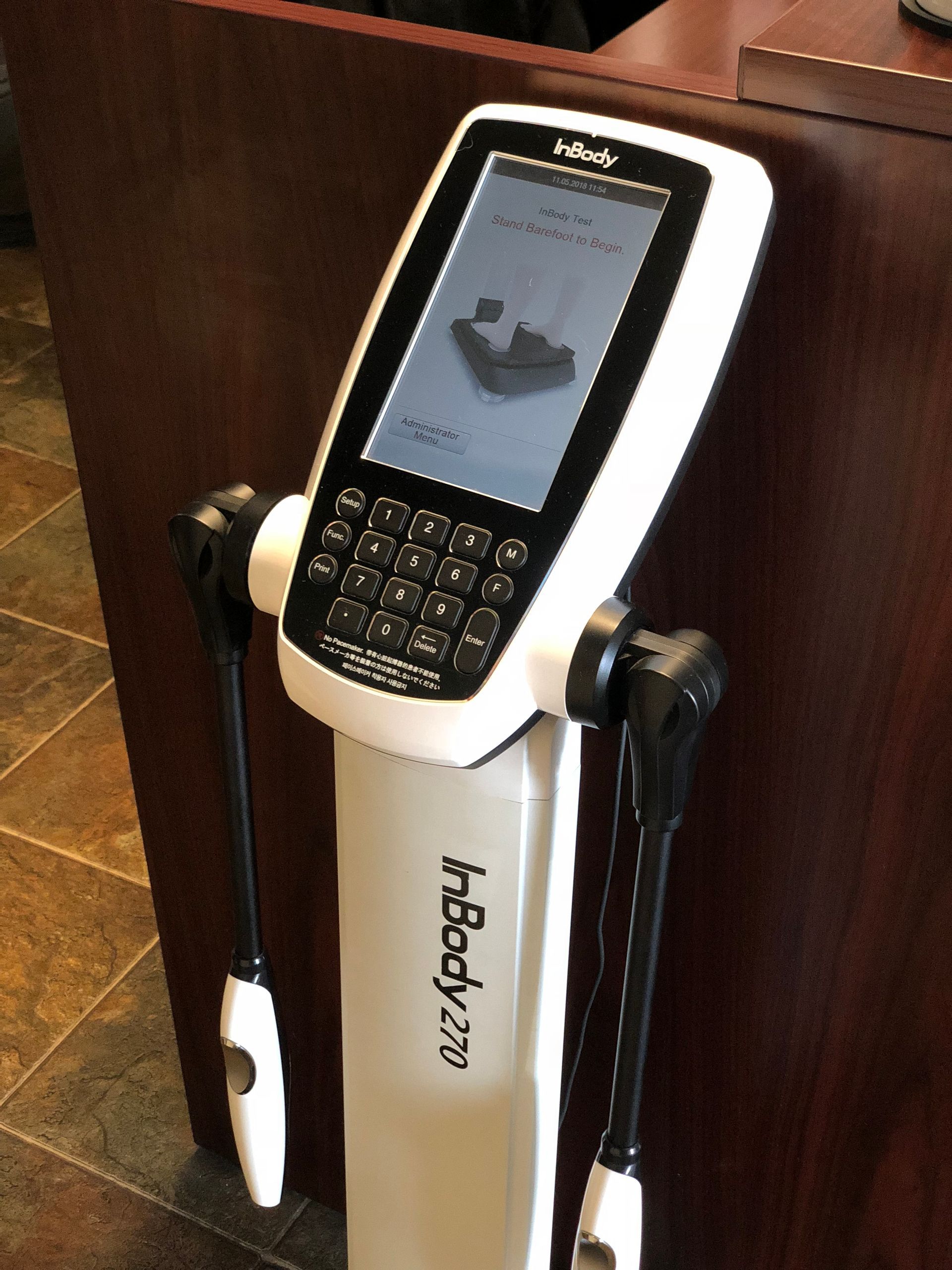 InBody 270 body composition analyzer. White device with screen and handles; buttons below.