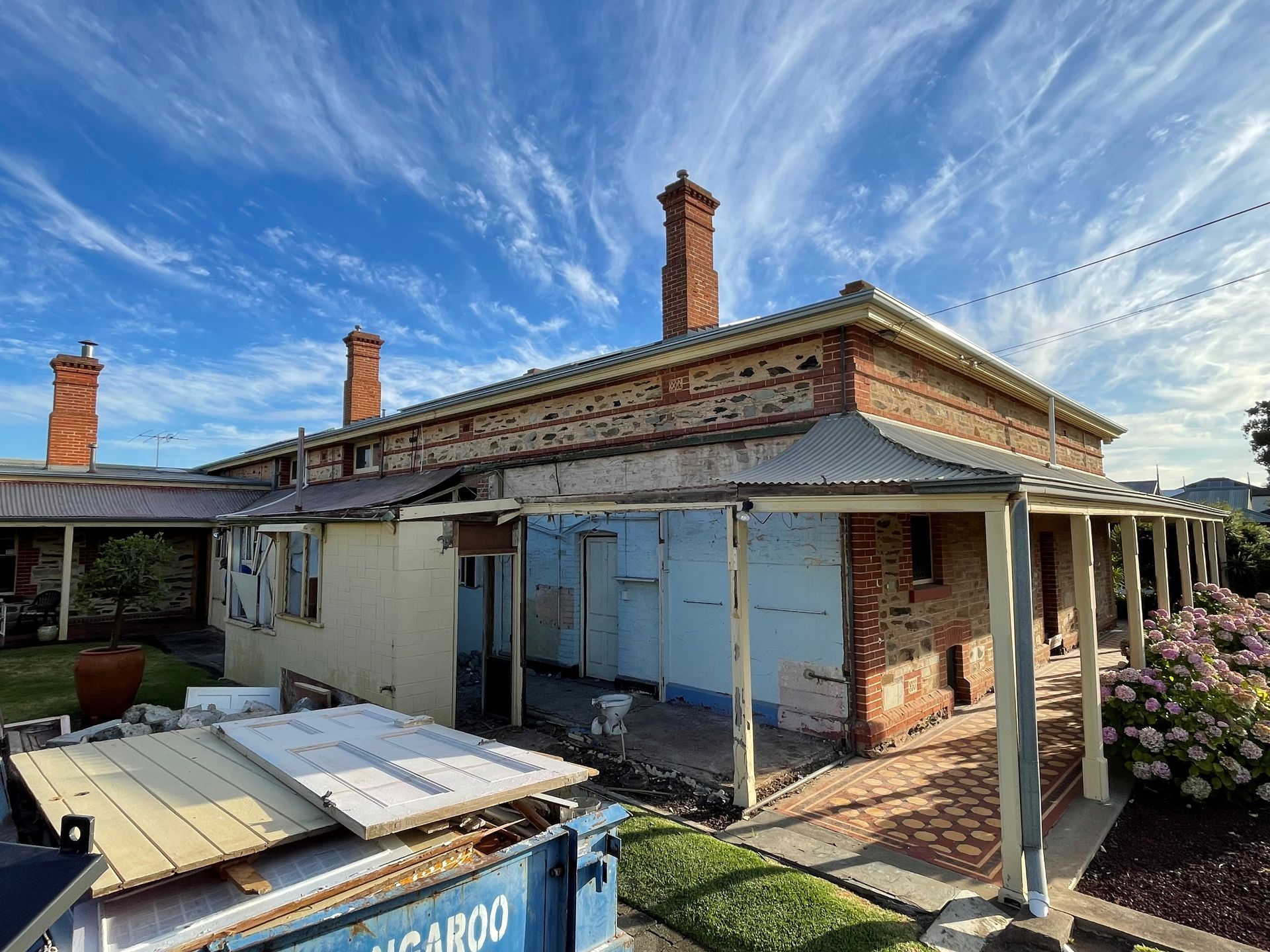A building under construction with a yellow ladder in the foreground