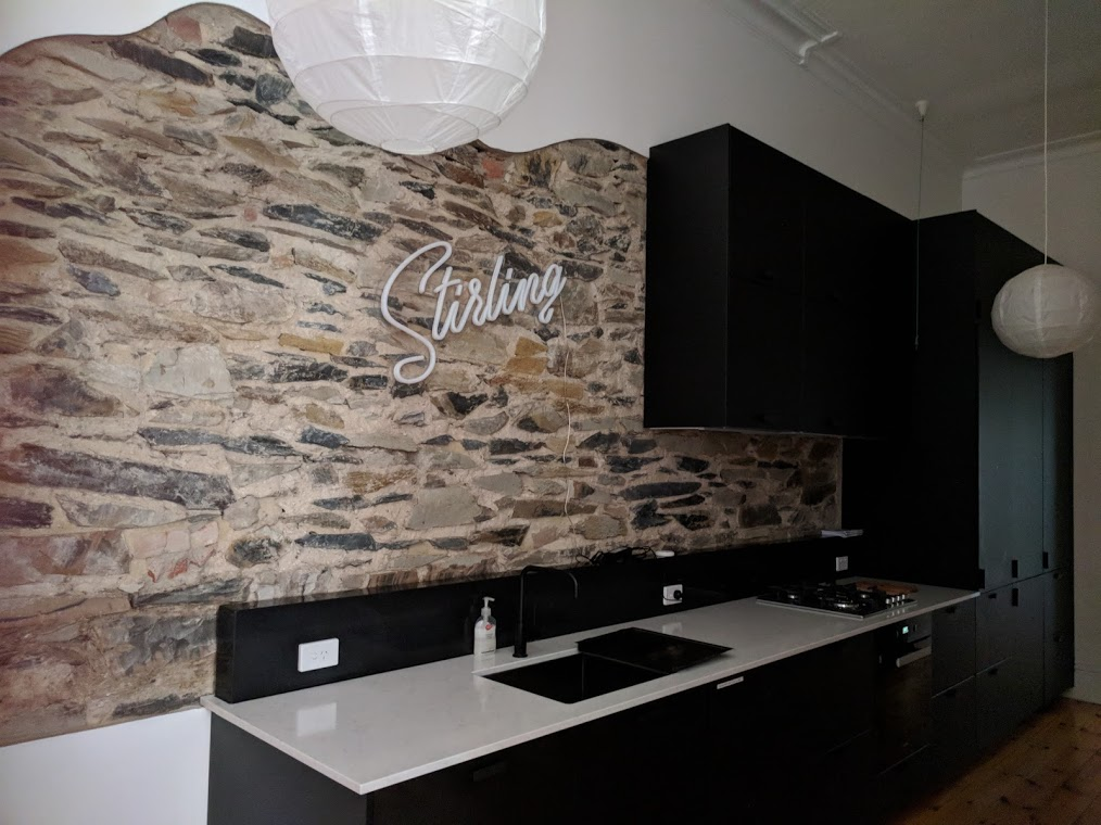 A ladder is sitting on the side of a building under construction