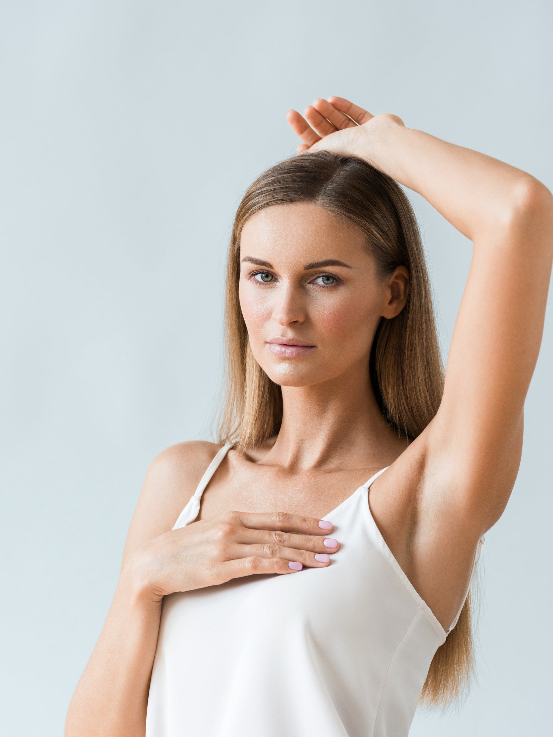woman with one arm up showing armpits