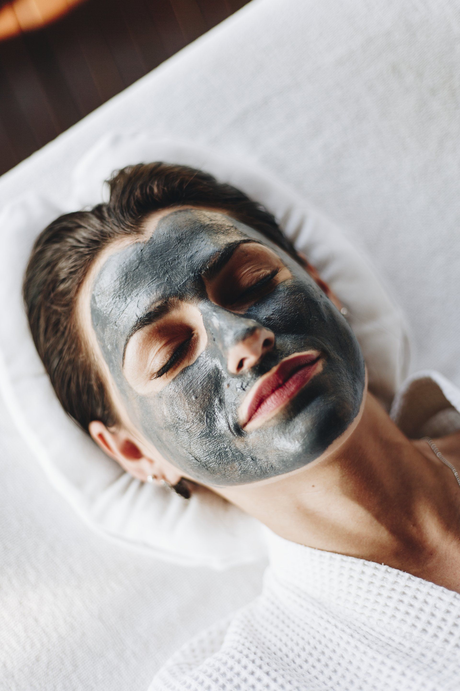 woman relaxing with a facial mask at the spa