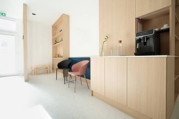 A waiting room with chairs and a coffee machine.