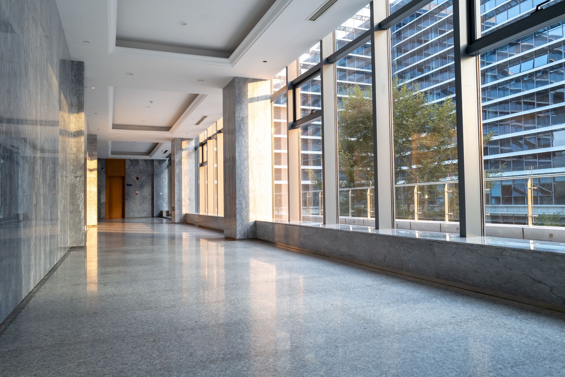 An empty room with hardwood floors and a window.