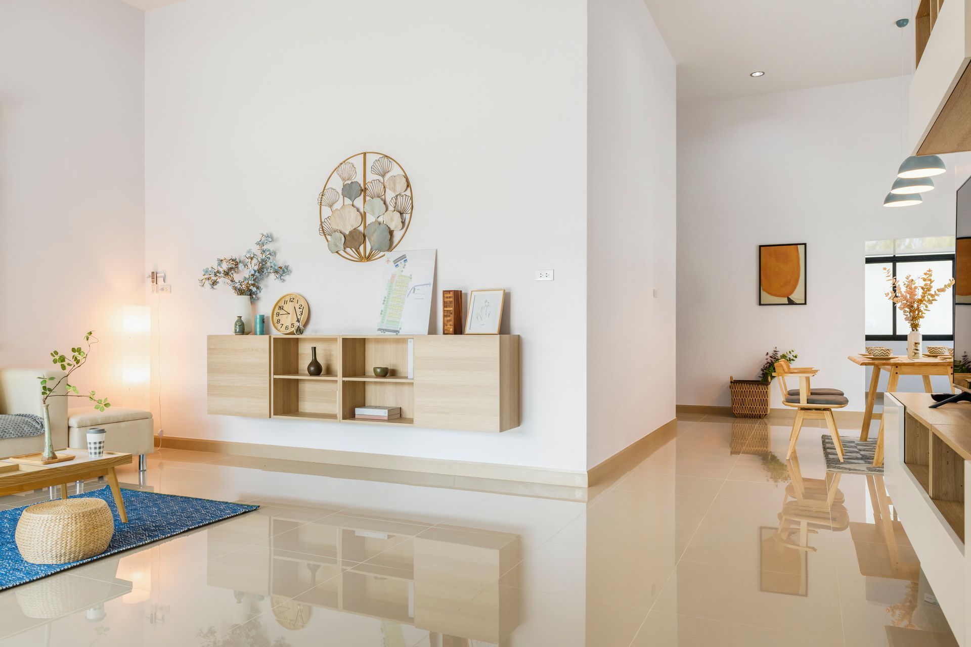 A living room filled with furniture and a clock on the wall.