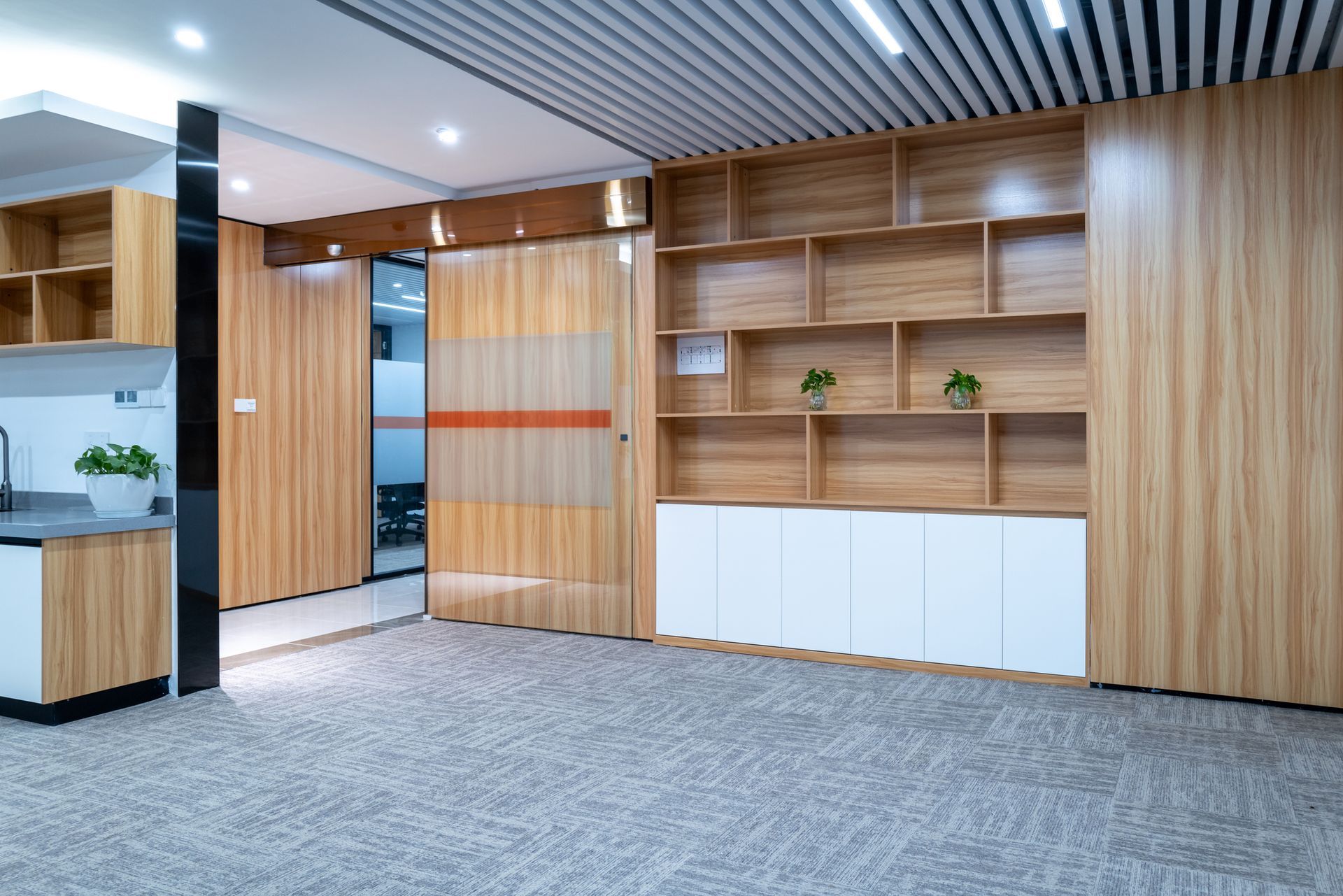 A large empty room with wooden shelves and cabinets.