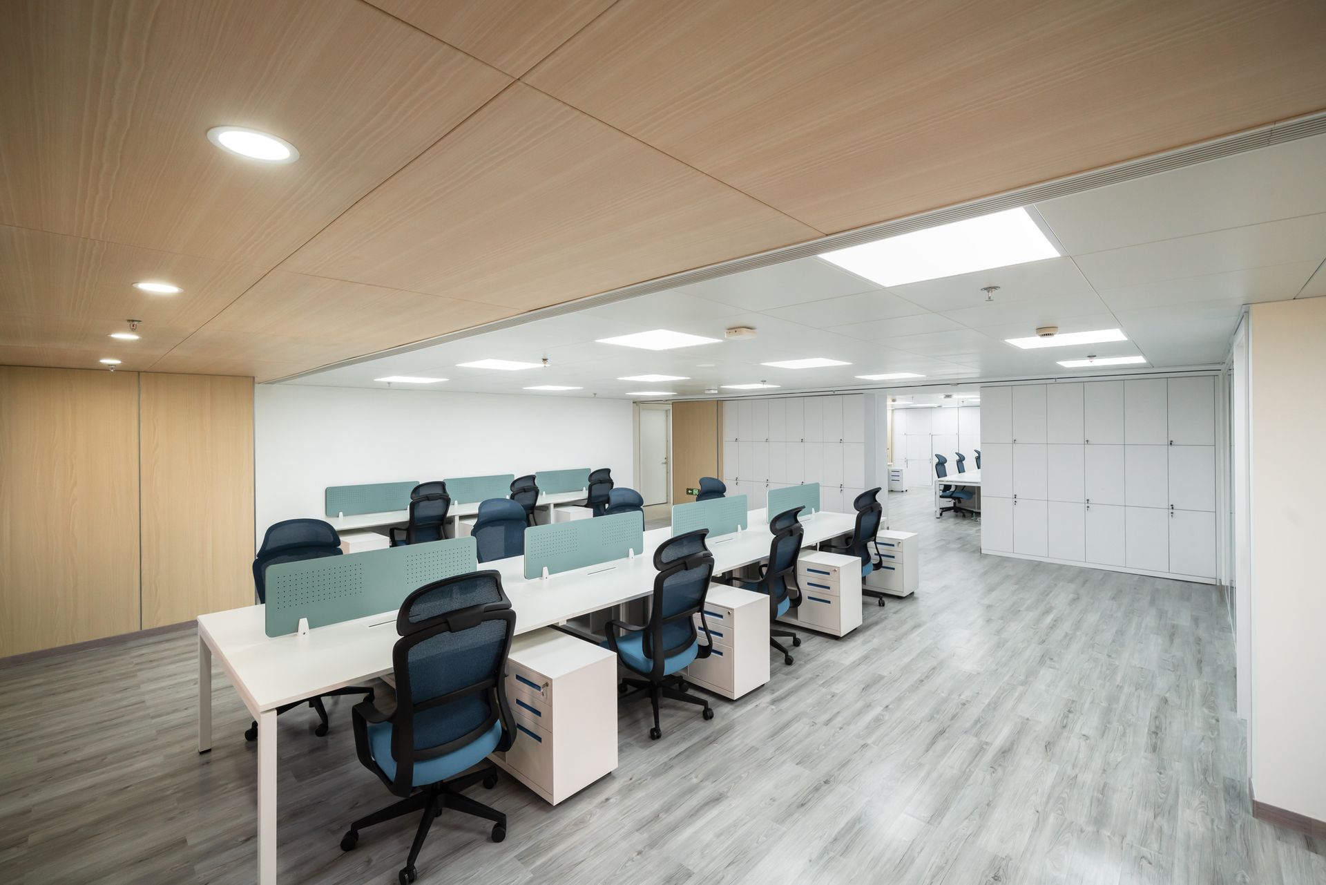 A large office with a lot of desks and chairs.