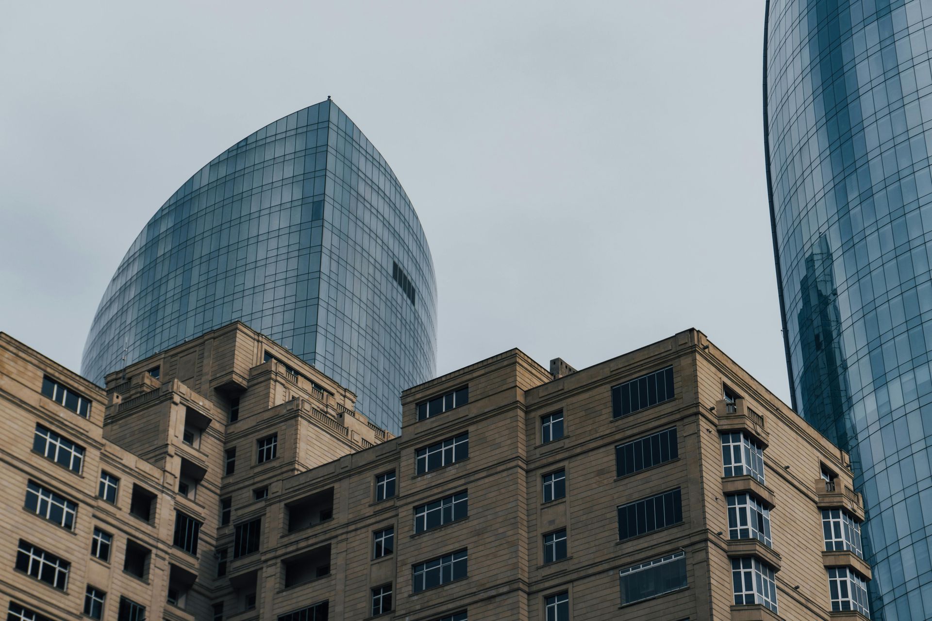 A commercial building with a high-rise tower behind