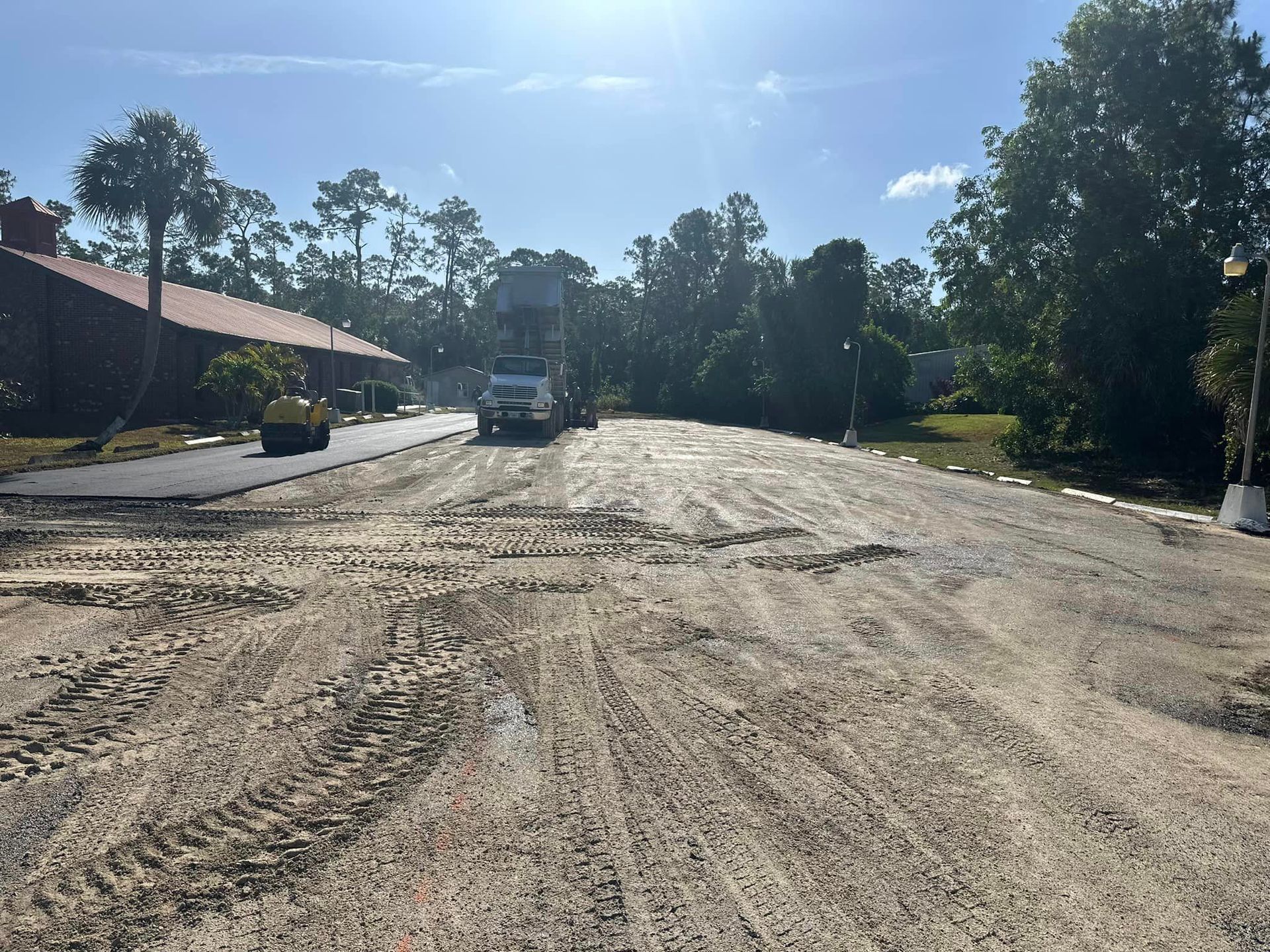 Truck Is Driving Down Dirt Road - Naples, FL - Apex Asphalt & Seal Coating