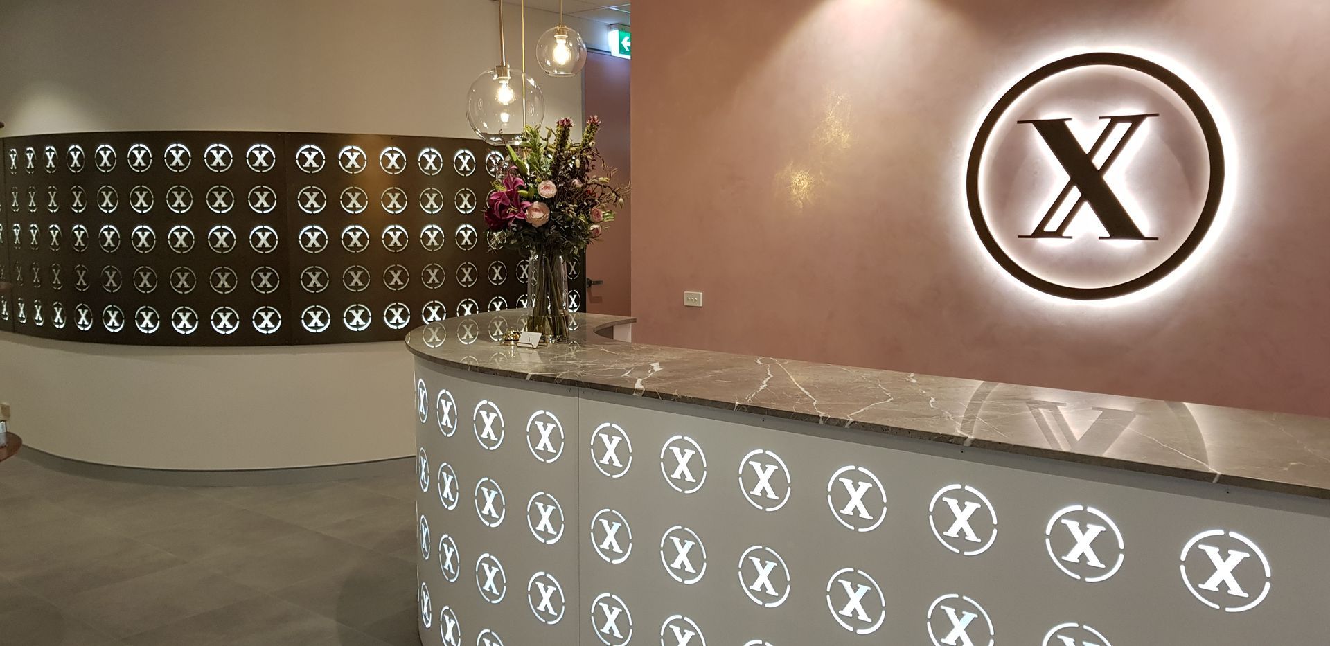 A reception desk with a sign that says x on it