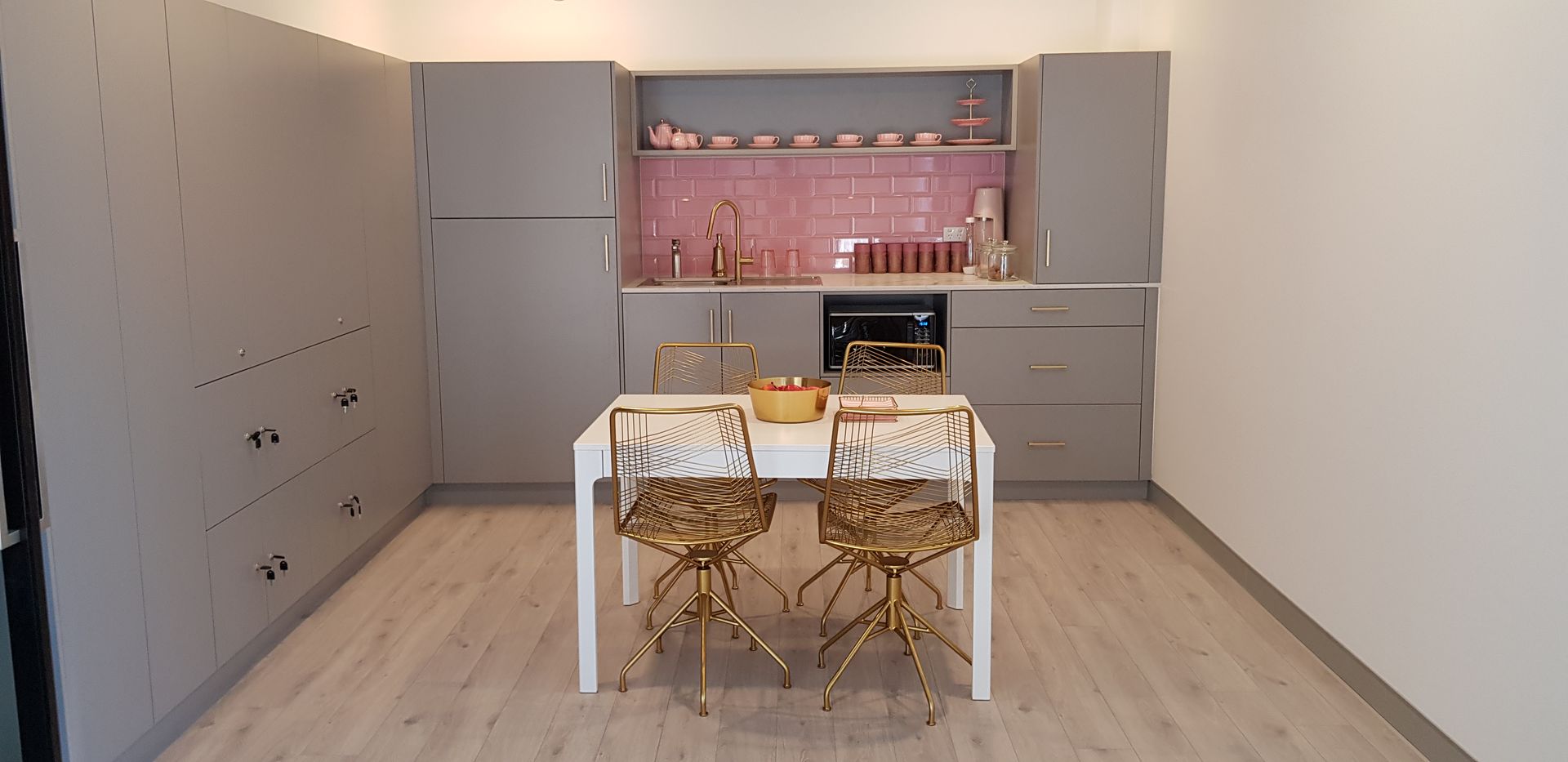 A kitchen with a table and chairs in it