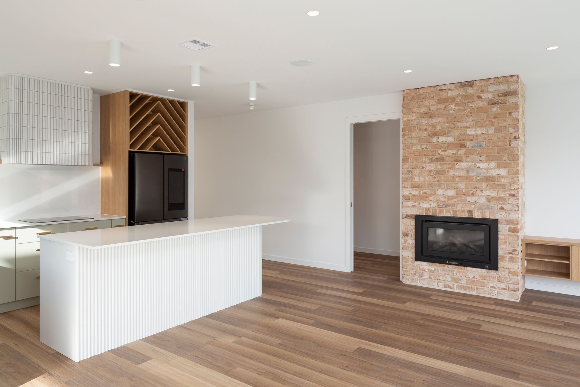 There is a fireplace in the middle of the room in the kitchen.