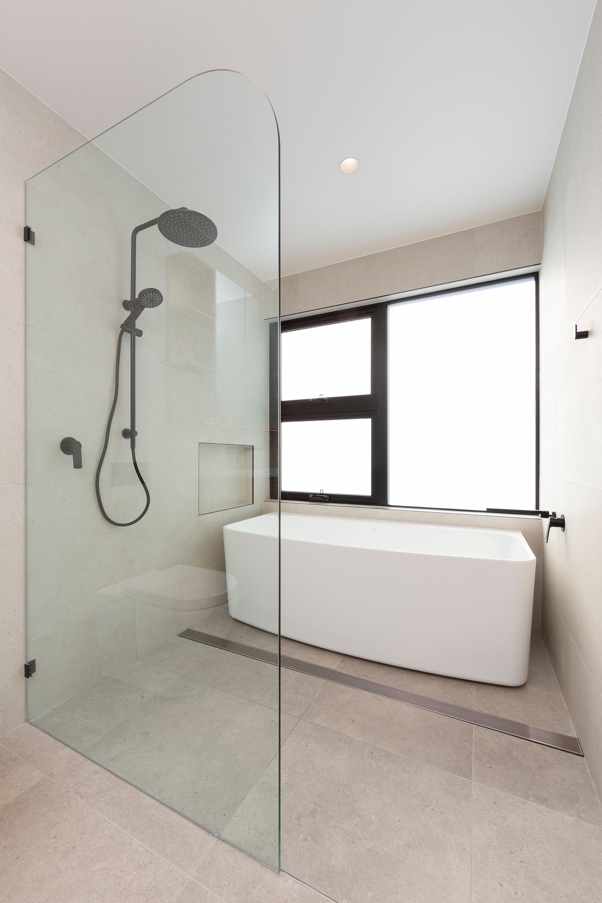 A bathroom with a walk in shower and a bathtub.