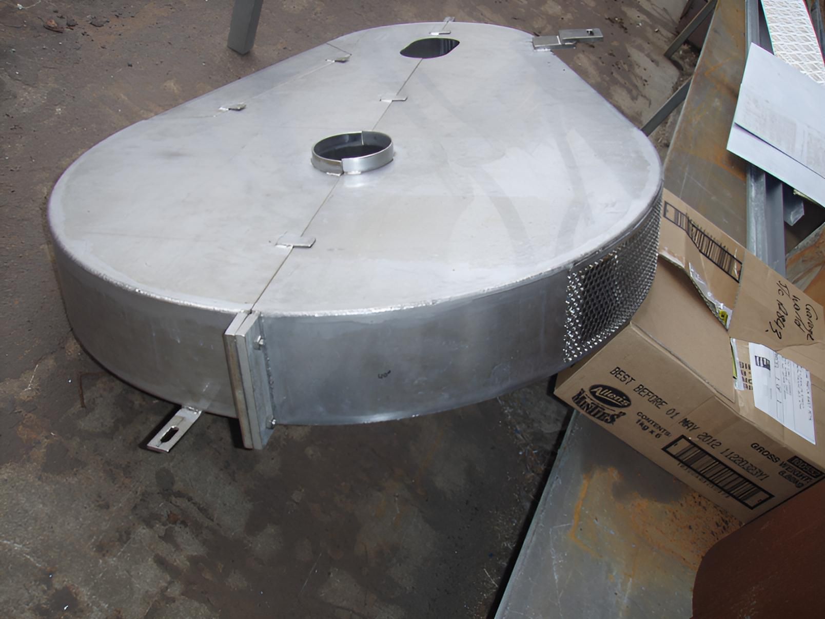 A Stainless Steel Object Is Sitting Next To A Cardboard Box — Brian Martin's Sheet Metal In North Mackay, QLD