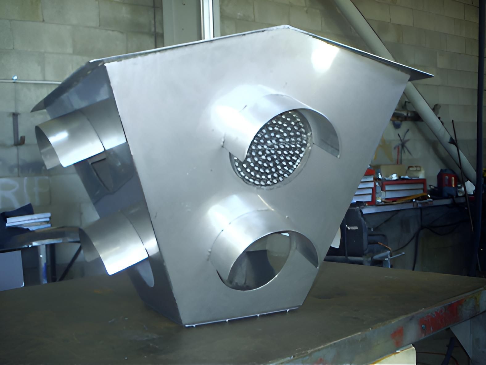 A Metal Object With Holes In It Is Sitting On A Table — Brian Martin's Sheet Metal In North Mackay, QLD
