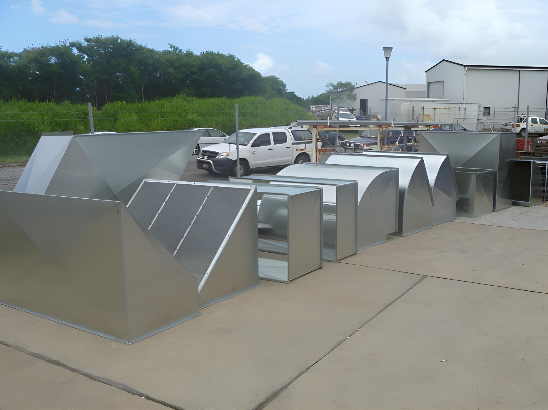 A White Truck is Parked In Front Of A Bunch Of Stainless Steel Pipes — Brian Martin's Sheet Metal In North Mackay, QLD