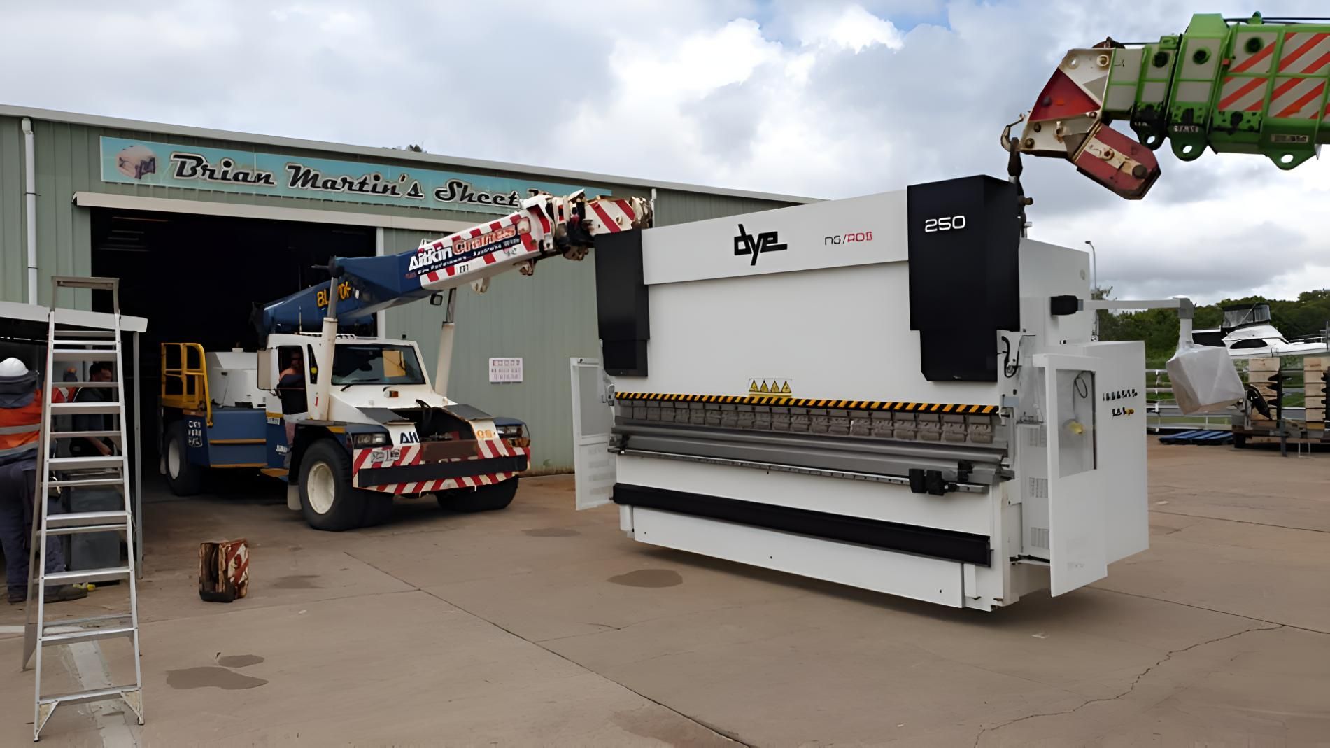 A Large Machine Is Parked In Front Of A Building — Brian Martin's Sheet Metal In North Mackay, QLD