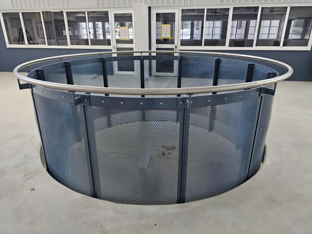 A Circular Metal Fence With A Metal Railing Is In Front Of A Building — Brian Martin's Sheet Metal In Moranbah, QLD