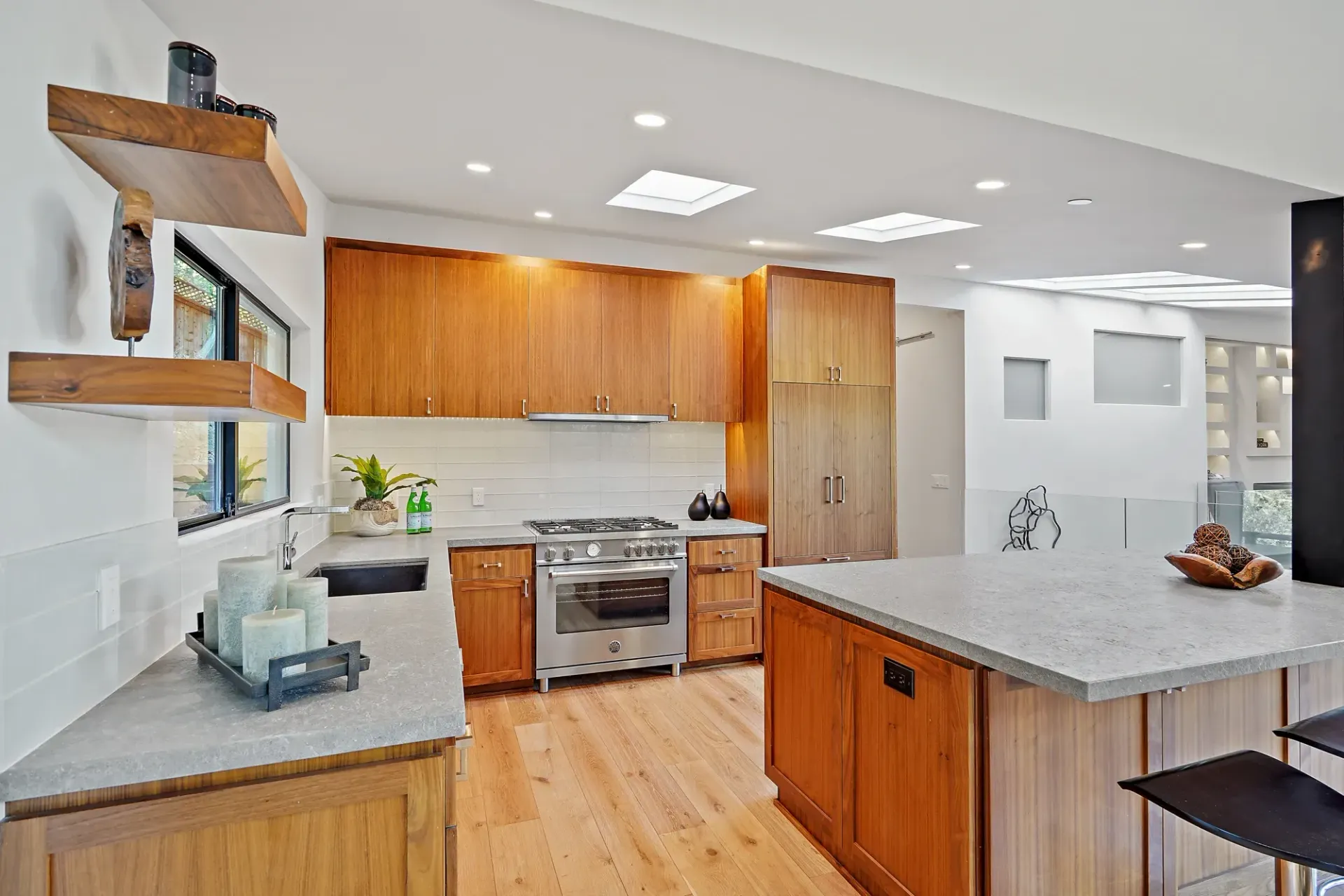 Kitchen with wooden cabinets, stainless steel appliances, and a light-colored countertop island.