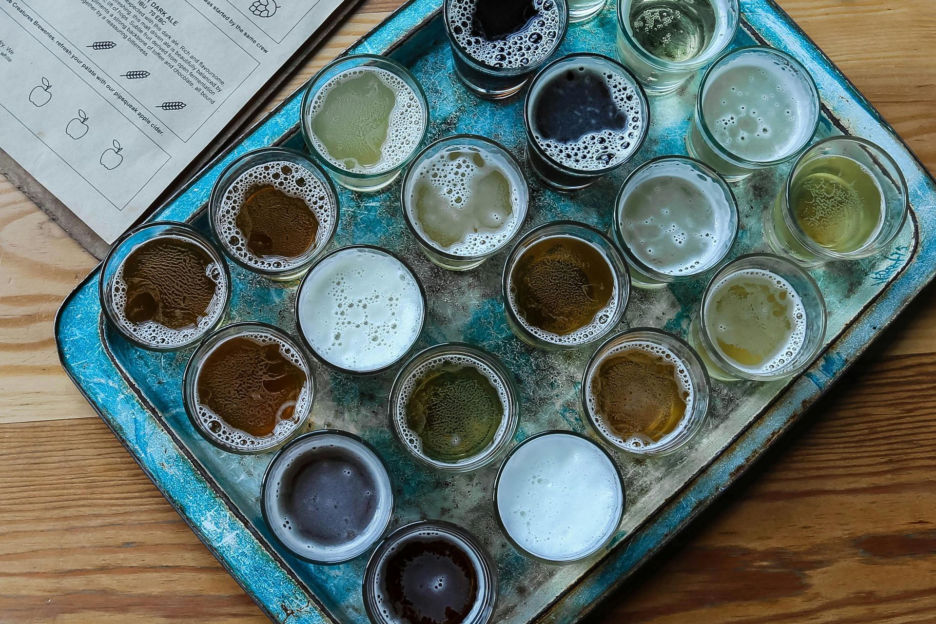 A selection of Normandy ciders arranged on a tasting tray, showcasing regional flavors.