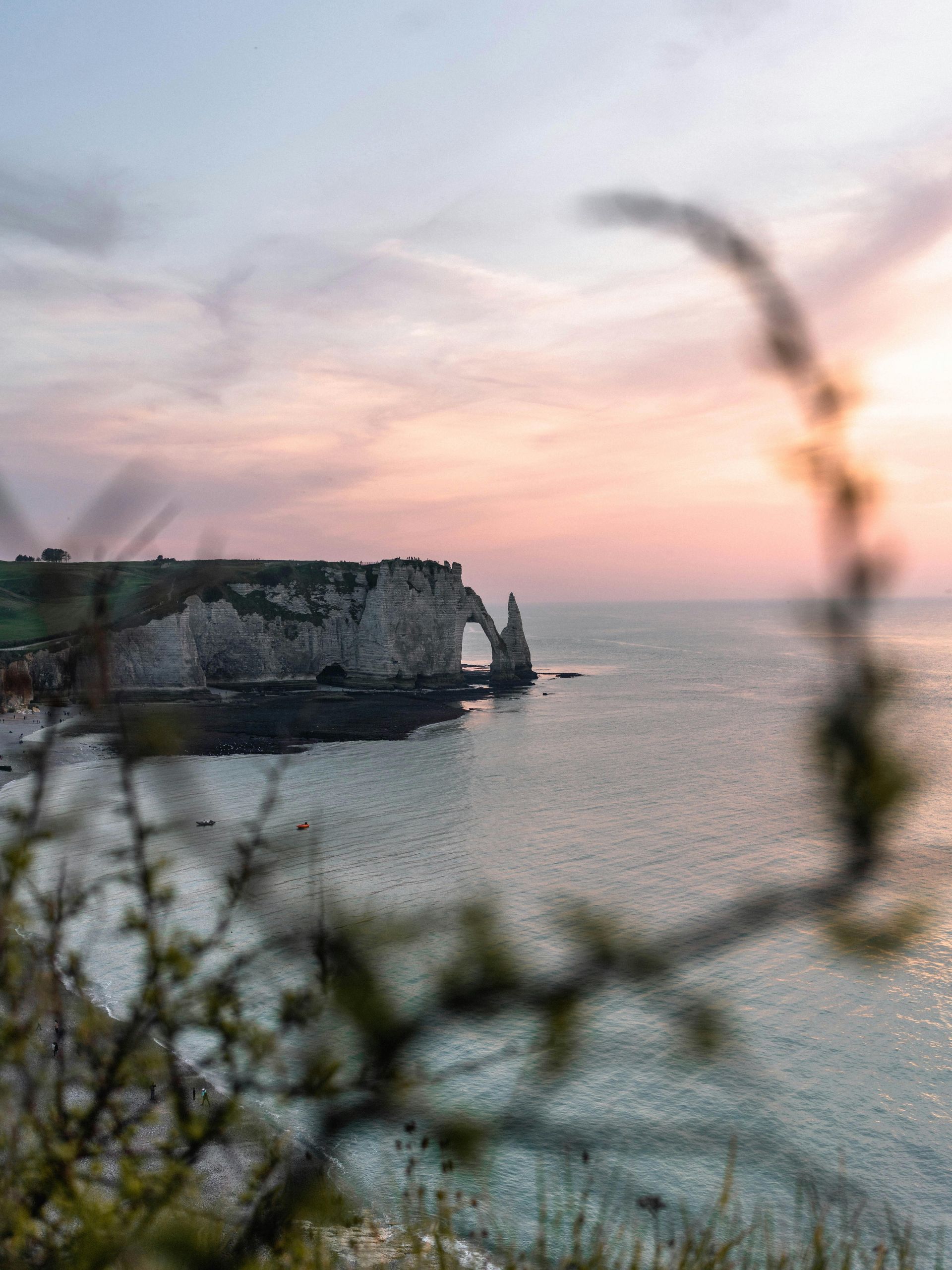 Scenic view of the white limestone cliffs of Étretat, Normandy, at sunset.