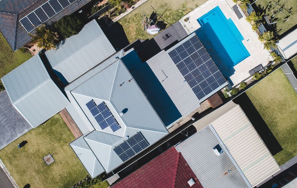 Overhead View of Houses With Solar Panels on Rooftops — Solar Services in Erina, NSW