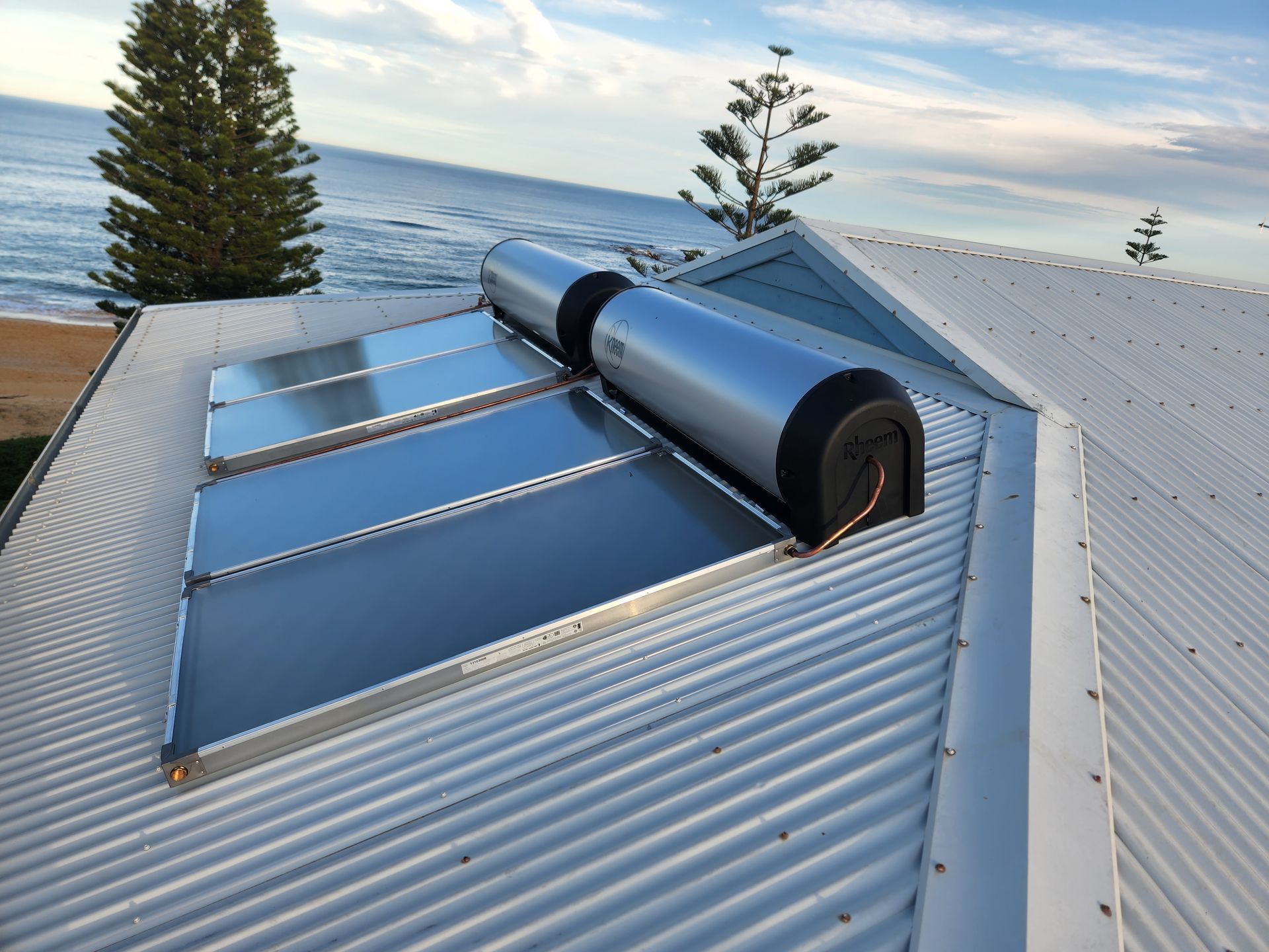 A Row of Solar Panels on the Roof of a Building — Solar Services in Erina, NSW
