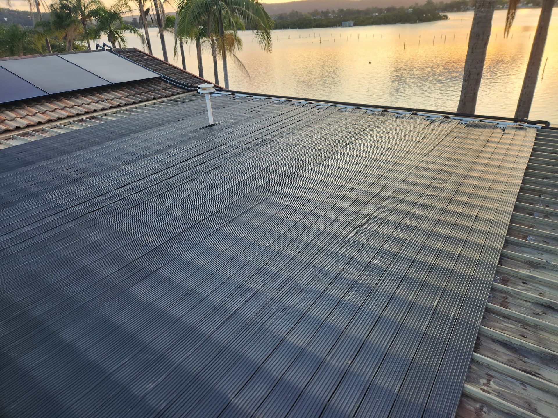 The Roof of a Building With Solar Panels on It — Solar Services in Bateau Bay, NSW