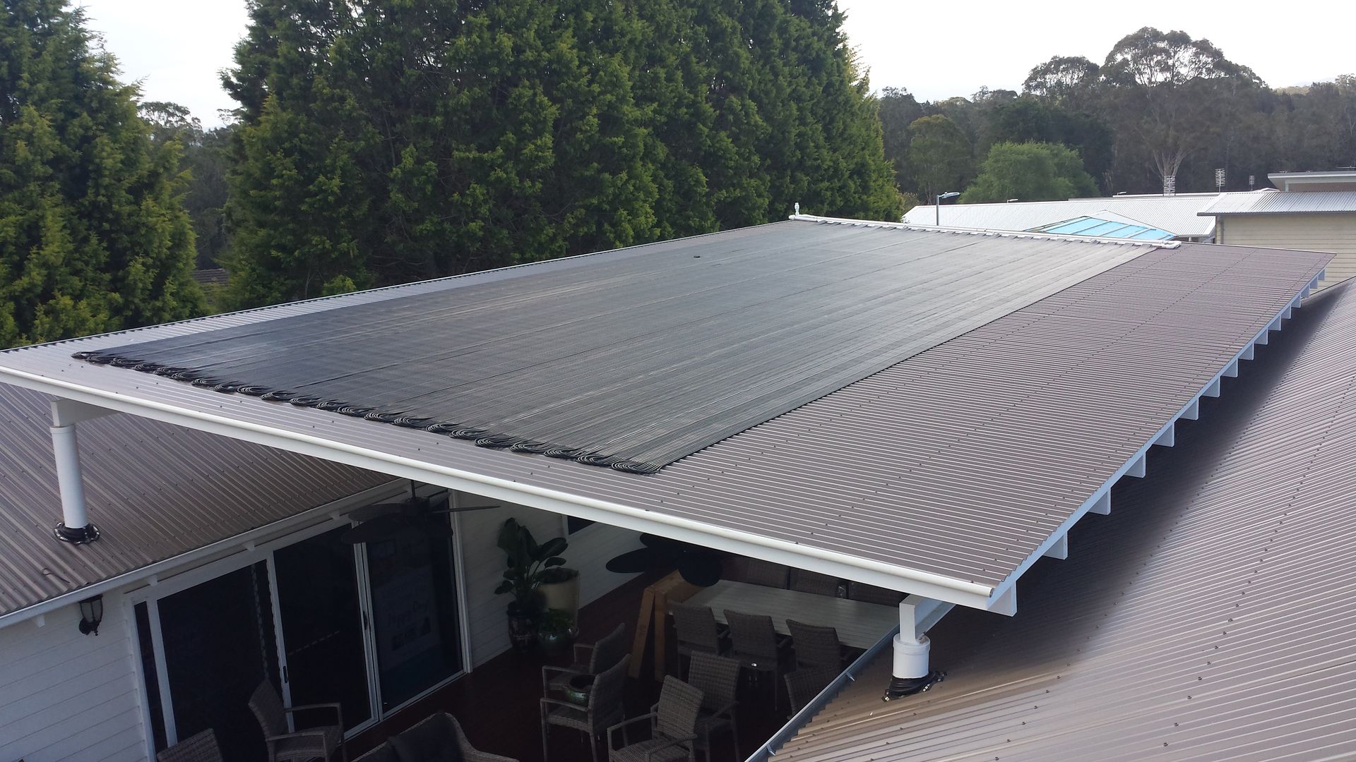 A Row of Solar Panels Sitting on Top of a roof — Solar Services in Bateau Bay, NSW