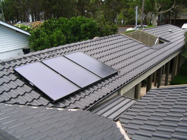 Solar Water Heater Black Panels on a roof — Solar Services in Erina, NSW