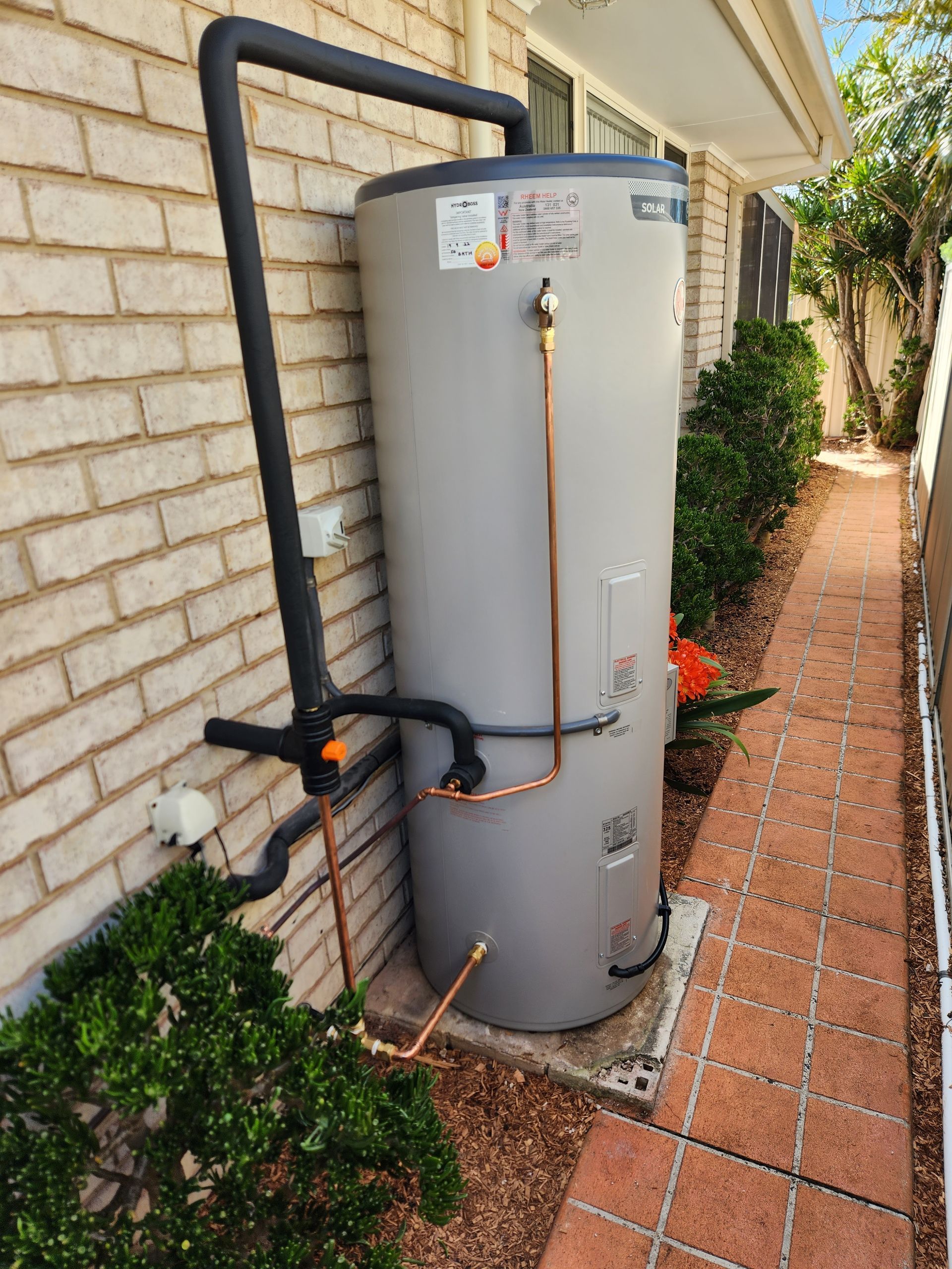 A Water Heater With Copper Pipes — Solar Services in Erina, NSW