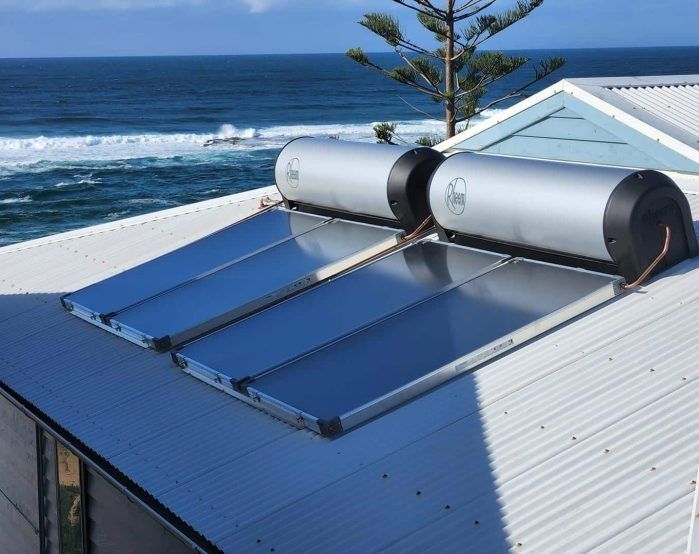 A Solar Water Heater is on the Roof of a House Overlooking the Ocean — Solar Services in Kincumber, NSW