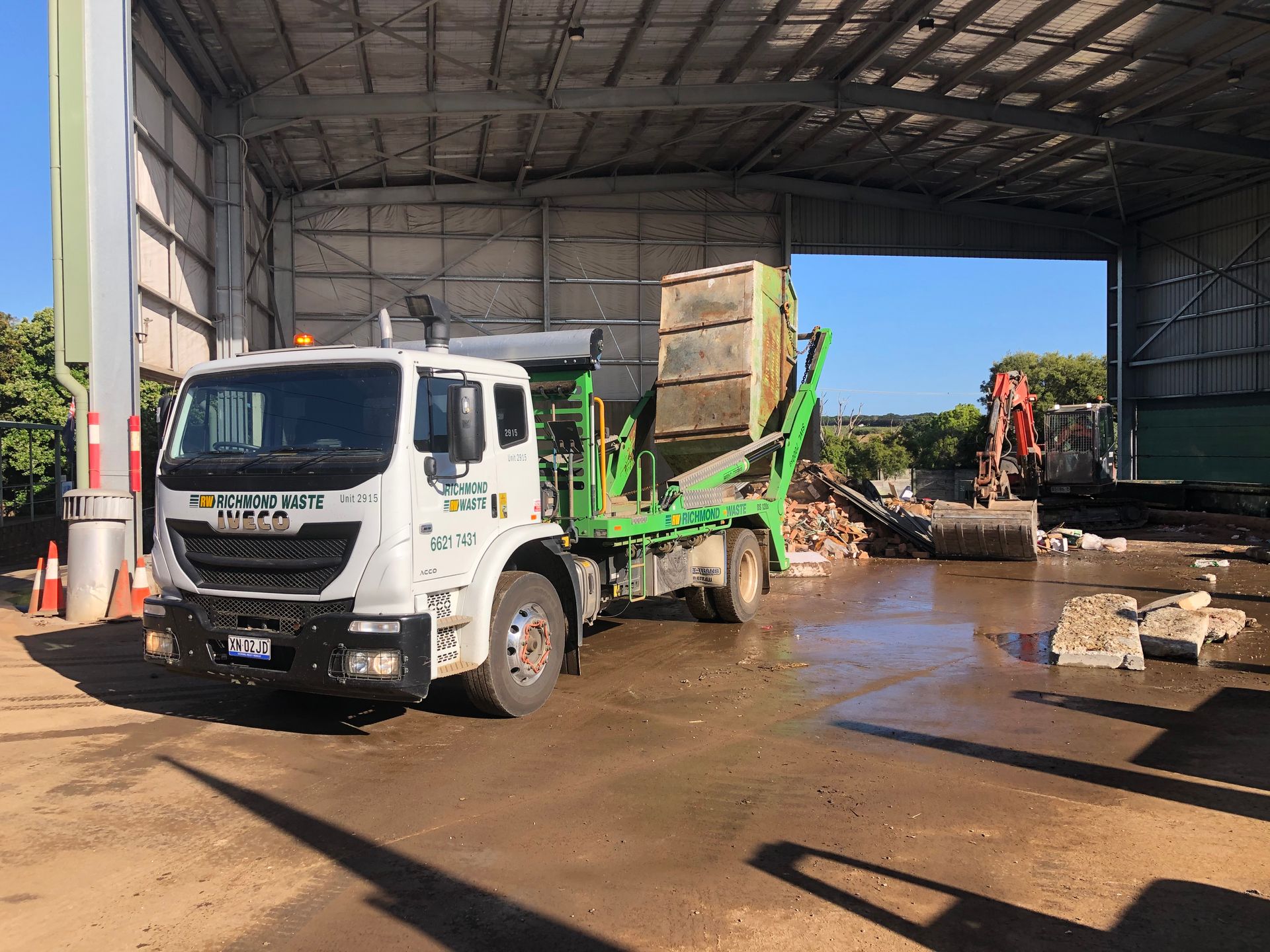 A large Richmond Waste truck is parked in a dump yard while tipping tray upwards — Hasti Skips in Mullumbimby, NSW