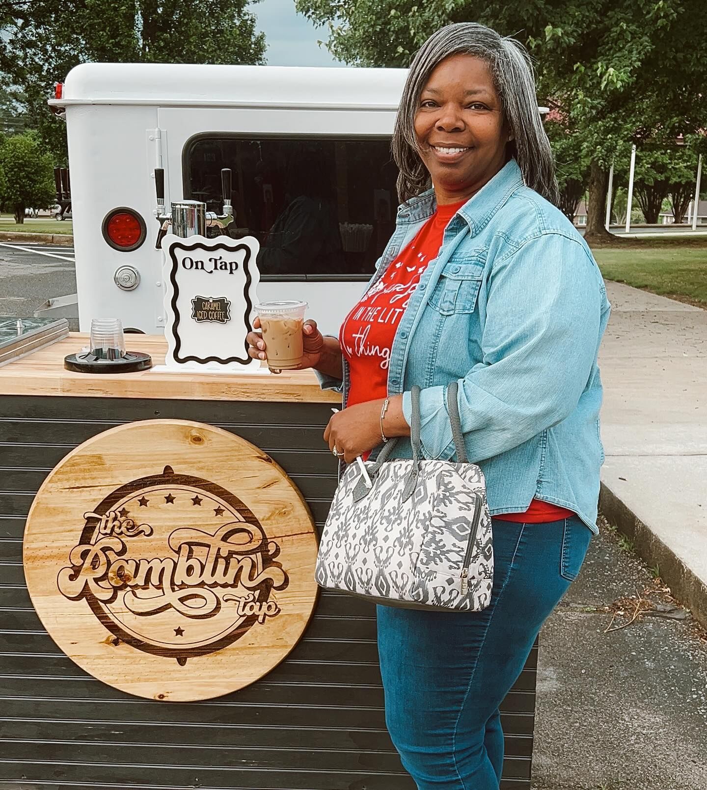 A woman standing in front of a sign that says i 'm busy