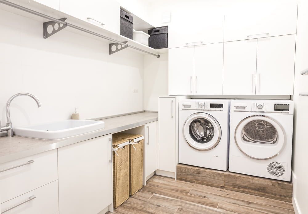 A Laundry Room With Two Washing Machines and a Sink — Foreshore Plumbers In Tuncurry, NSW