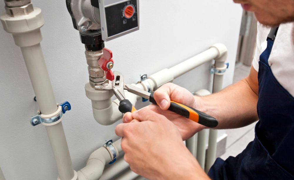 Plumber Fixing Issues with Hot Water Systems