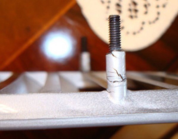 A close up of a screw on a piece of metal