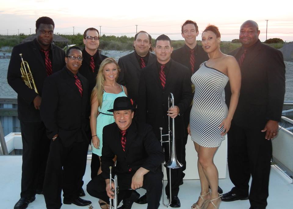 A group of people posing for a picture on a boat
