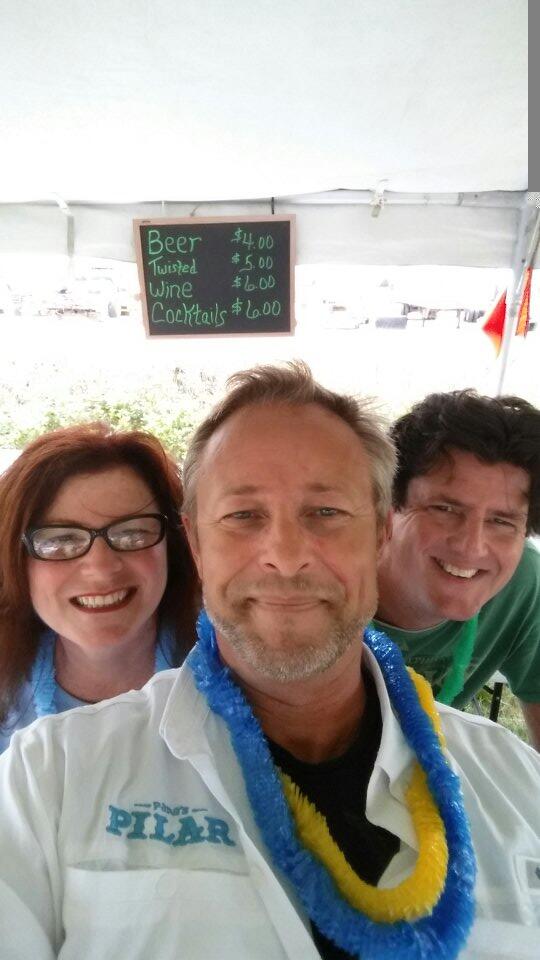A man wearing a white jacket with the word pillar on it