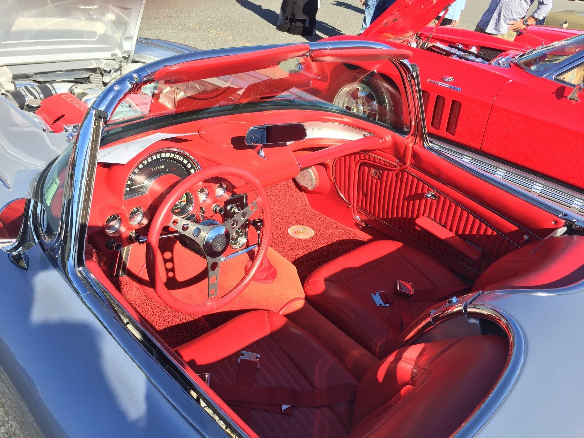 The interior of a car with red seats and a steering wheel