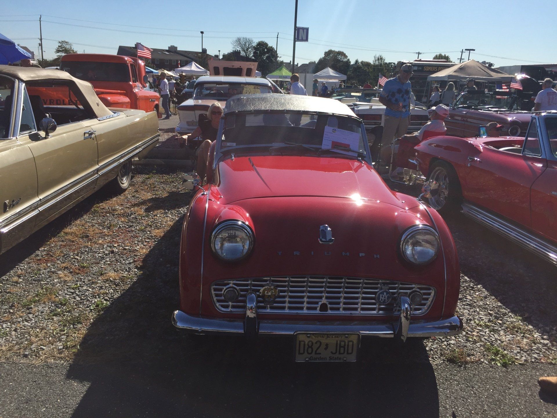 A red car with a new jersey license plate
