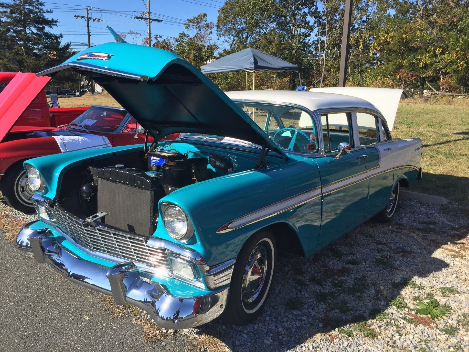 A blue and white car with the hood open