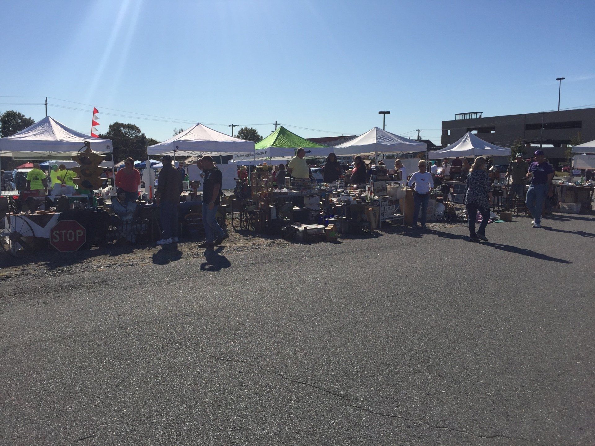A stop sign is in the middle of a parking lot