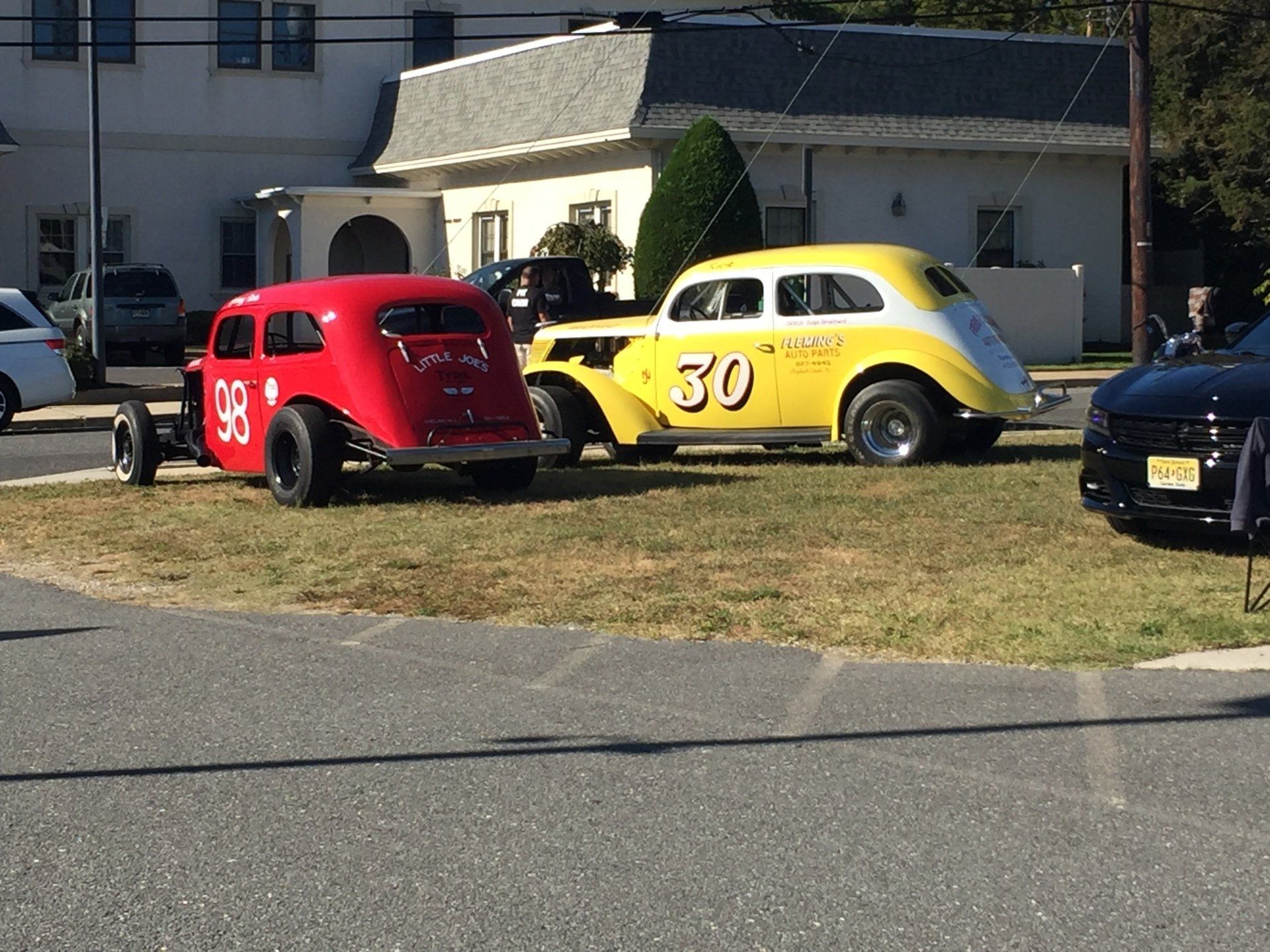 A red car with the number 33 on it is parked next to a yellow car with the number 30 on it