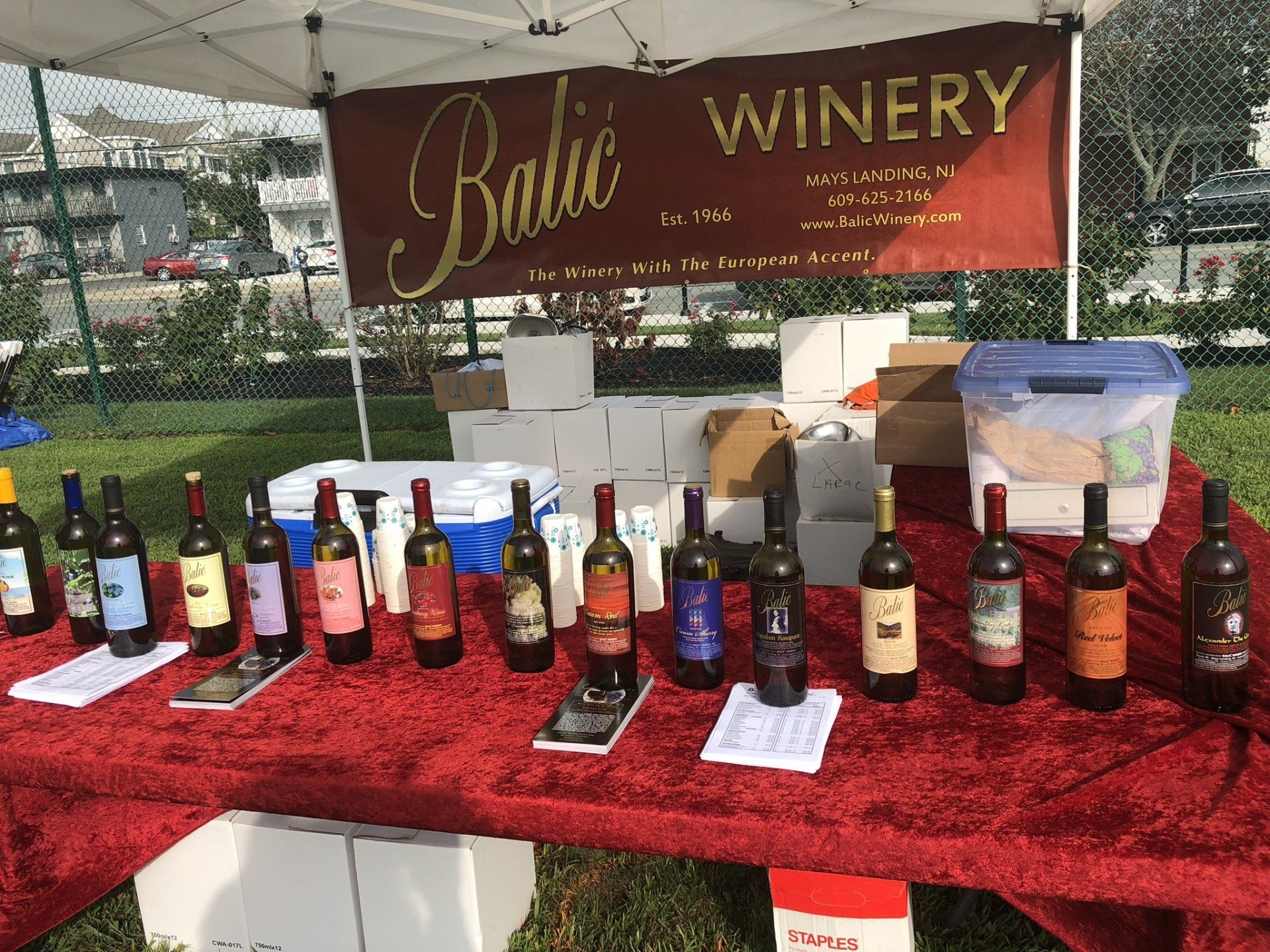 Bottles of wine are lined up on a table under a banner that says baltic winery