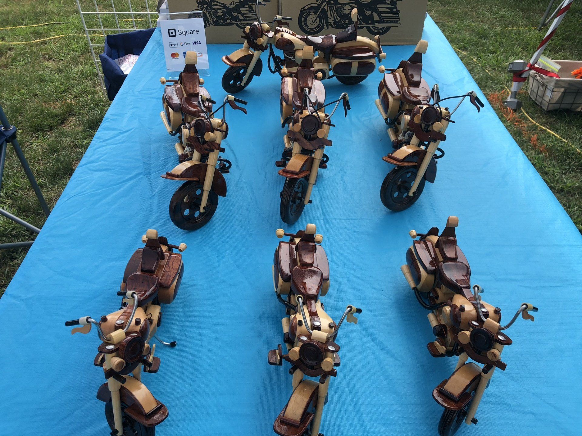 A table with a bunch of wooden motorcycles on it