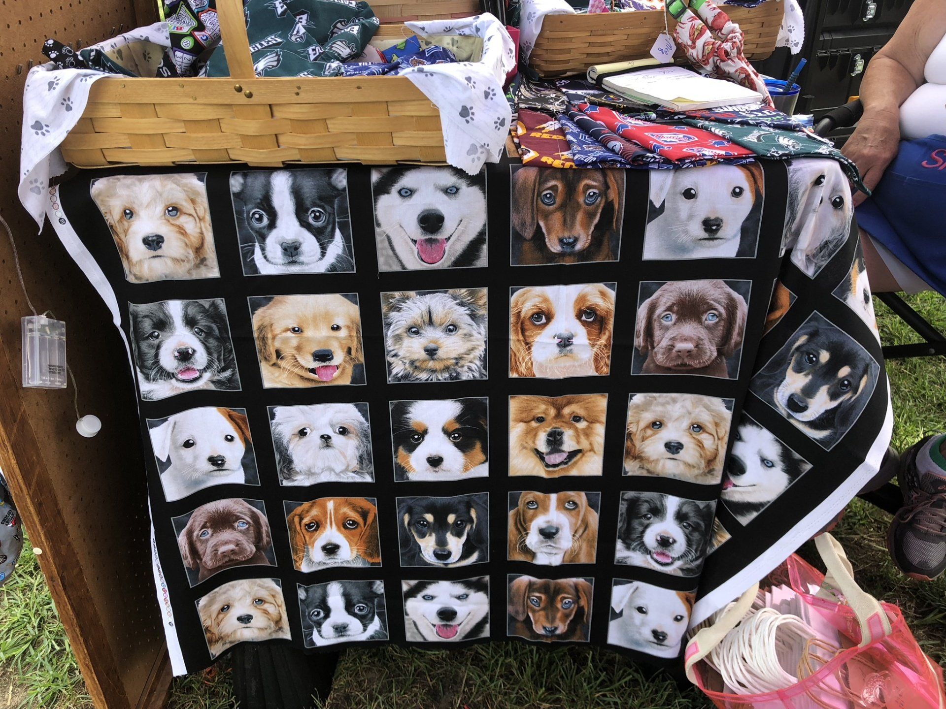 A table with a quilt of dogs on it